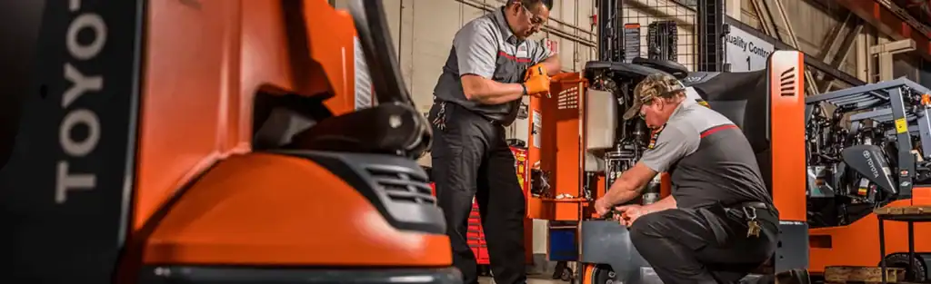 Forklift repair and maintenance at Castle Eden Lift Trucks facility. Expert technicians servicing industrial machinery.